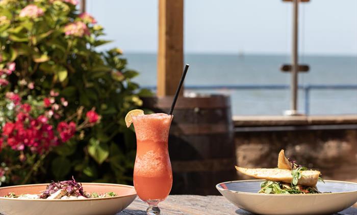 Chicken Salad and Cavolo Nero Pasta with a cocktail on our Promenade Terrace, overlooking the Irish Sea.